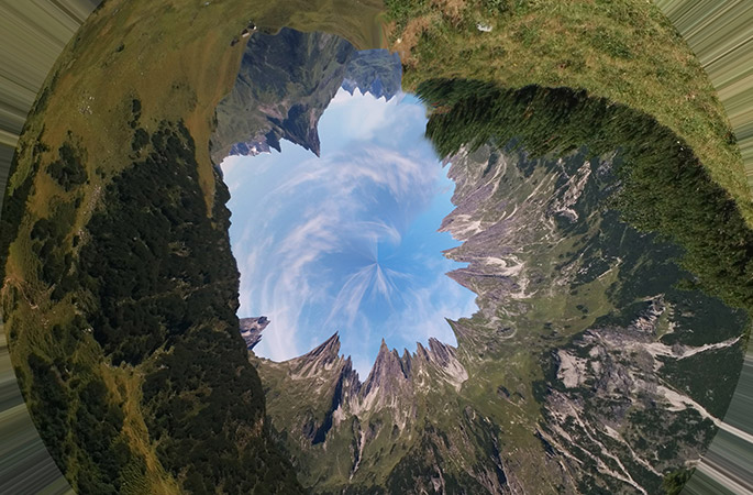 Inverted panorama of a mountainous landscape.